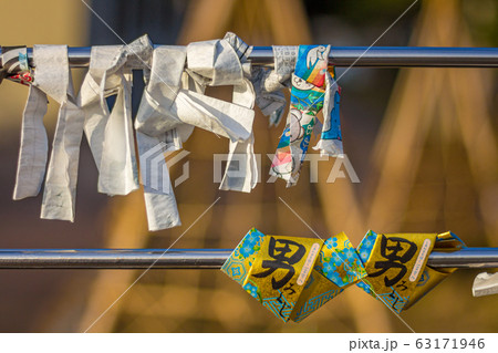 Traditional omikuji prayer paper, tied around pole. Traditional omikuji prayer paper, tied around pole. 63171946