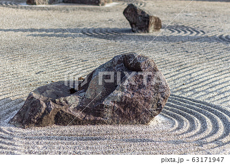 Japanese dry rock zen landscape garden, or karesansui, with raked sand or gravel to represent ripples in water. Kurikarafudoji temple, Tsubata, Japan. 63171947