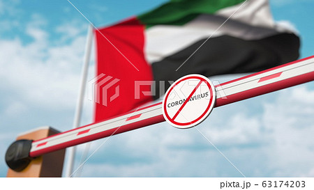 Closing boom barrier with STOP CORONAVIRUS sign against the UAE flag. Quarantine. 3D rendering  63174203