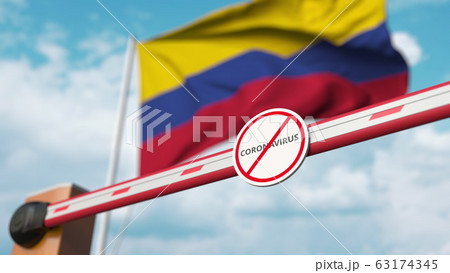 Closed boom gate with STOP CORONAVIRUS sign on the Colombian flag background. Quarantine in Colombia. 3D rendering  63174345
