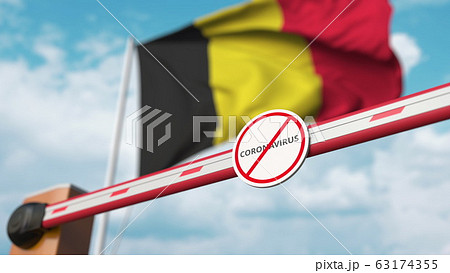 Barrier gate with STOP CORONAVIRUS sign being closed with flag of Belgium as a background. Belgian Quarantine. 3D rendering  63174355