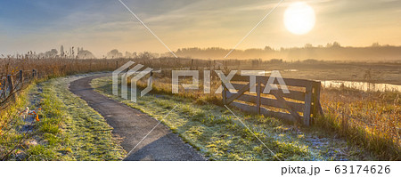 Gate in misty agricultural landscape Gate in misty agricultural landscape 63174626