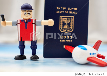 airport employees toy shows a ban on entering the country from quarantine against an Israeli passport airport employees toy shows a ban on entering the country from quarantine against an Israeli passport 63176774