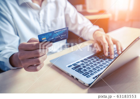 Young man use credit card for online shopping 63183553