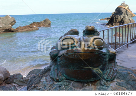 Frog statue at the Meoto Iwa "Married Couple Rocks" of Futami, in Mie Japan, a sacred Shinto island 63184377