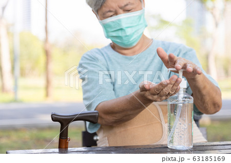 Asian elderly people wearing protective mask,using alcohol antiseptic gel,prevent infection,outbreak of Covid-19,senior woman washing hand with hand sanitizer to avoid contaminating with Coronavirus Asian elderly people wearing protective mask,using alcohol antiseptic gel,prevent infection,outbreak of Covid-19,senior woman washing hand with hand sanitizer to avoid contaminating with Coronavirus 63185169
