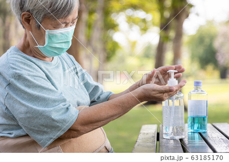 Asian elderly people wearing protective mask,using alcohol antiseptic gel,prevent infection,outbreak of Covid-19,senior woman washing hand with hand sanitizer to avoid contaminating with Coronavirus Asian elderly people wearing protective mask,using alcohol antiseptic gel,prevent infection,outbreak of Covid-19,senior woman washing hand with hand sanitizer to avoid contaminating with Coronavirus 63185170