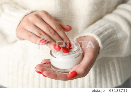 Woman holding jar of moisturizing cream, closeup. Woman holding jar of moisturizing cream, closeup. 63188731