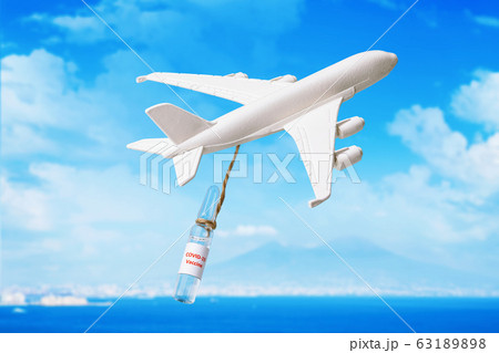 Toy airplane and ampoule with vaccine against the new coronavirus COVID-19. Drug Delivery Concept Toy airplane and ampoule with vaccine against the new coronavirus COVID-19. Drug Delivery Concept 63189898
