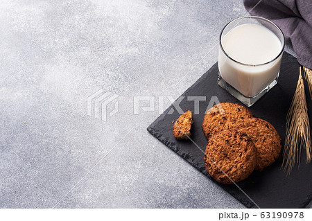 Homemade cookies cereals oats and a glass of milk 63190978