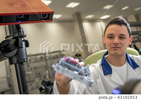 Quality engineer examines a sample scanned with a laser on a 3d scan in a research laboratory 63192053