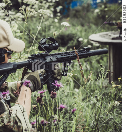 A military man or airsoft player in a camouflage A military man or airsoft player in a camouflage 63192602