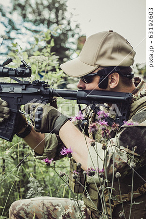 A military man or airsoft player in a camouflage 63192603