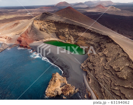 Volcanic crater with a green lake near El Golfo, Lanzarote, Spain. Aerial view Volcanic crater with a green lake near El Golfo, Lanzarote, Spain. Aerial view 63194062
