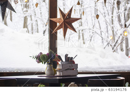 A table with a small bouquet in a cafe by the window. winter A table with a small bouquet in a cafe by the window. winter 63194176