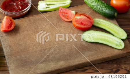 Wooden cutting board with tomatoes, cucumbers and empty space Wooden cutting board with tomatoes, cucumbers and empty space 63196291