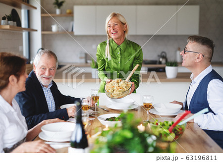 Group of senior friends at dinner party at home. 63196811