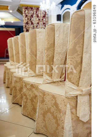 chairs in a row near a table set in the restaurant 63196849