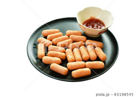 mini chicken sausage on plate dipping with ketchup 63198545