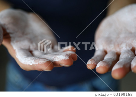 Male hands smeared with magnesium powder ready to workout 63199168