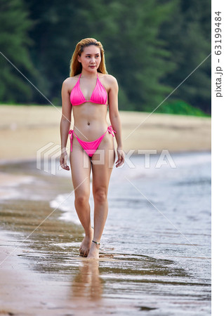 Young asian girl in pink bikini walking at Young asian girl in pink bikini walking at 63199484