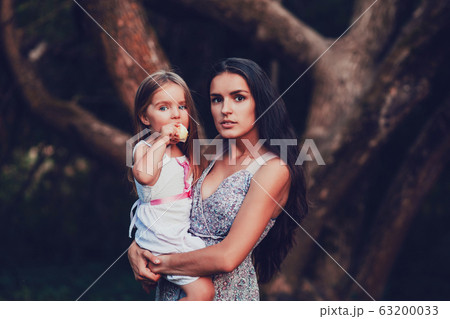 mother and daughter in the summer garden mother and daughter in the summer garden 63200033