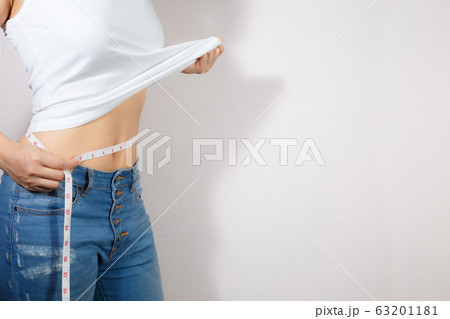 Healthcare and woman diet lifestyle concept to reduce belly and shape up healthy stomach muscle. 63201181