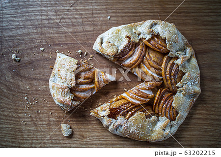 apple galette - pie on white baking parchment. Copy space, flat lay apple galette - pie on white baking parchment. Copy space, flat lay 63202215