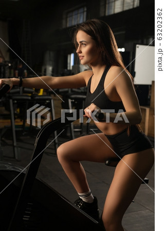 Fit woman training on bike in sport club Fit woman training on bike in sport club 63202362