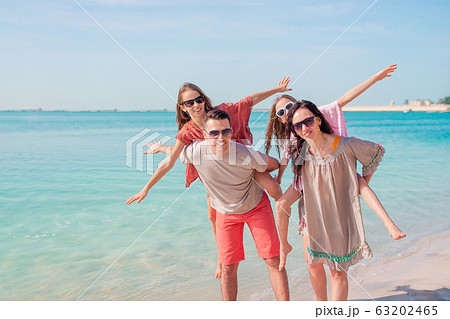Happy beautiful family on a tropical beach vacation Happy beautiful family on a tropical beach vacation 63202465