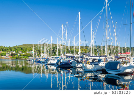Sailing boats docked at Tarbert marina. Sailing boats docked at Tarbert marina. 63203229
