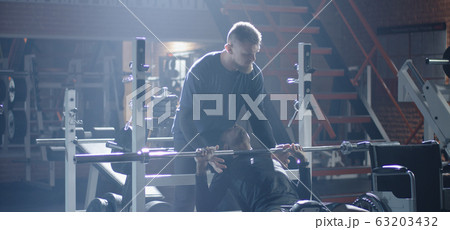 Wheelchair man lifting weight in gym Wheelchair man lifting weight in gym 63203432