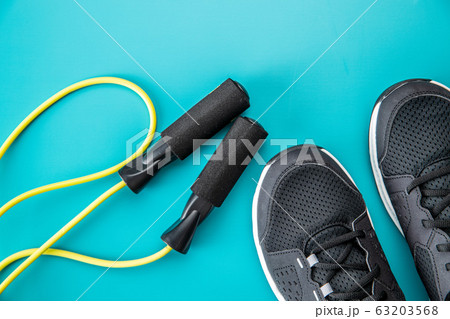 Black sport shoes and jump rope. 63203568