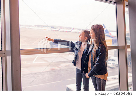 Little kid in airport waiting for boarding Little kid in airport waiting for boarding 63204065