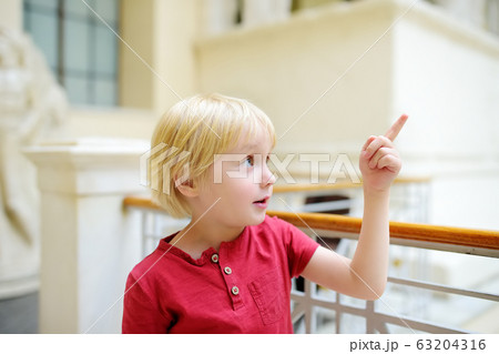 Little boy looking at sculptures during excursion Little boy looking at sculptures during excursion 63204316