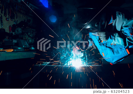 Welders working at the factory made metal 63204523