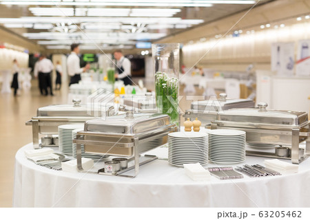 Waiters prepare buffet before a coffee break at business conference meeting. 63205462