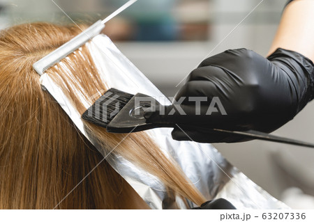 Professional hairdresser using sterile instruments while dying 63207336