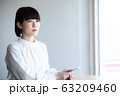 カフェでたたずむ女性 63209460