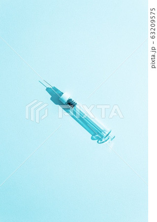 Syringe close up. Monochrome blue medicine concept. Syringe close up. Monochrome blue medicine concept. 63209575