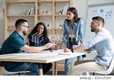 Focused mixed race business people company employees discussing project. 63212263