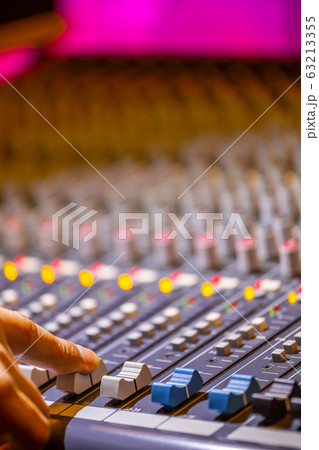 sound engineer fingers adjusting on audio mixing console fader. recording, broadcasting concept sound engineer fingers adjusting on audio mixing console fader. recording, broadcasting concept 63213355