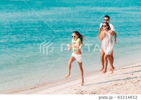 Happy beautiful family on a tropical beach vacation 63214652