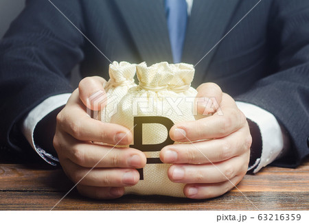 Businessman hugs russian ruble money bags. Budget, tax collection. Granting financing business project or education. Trade, economics. Corruption. Provision financial loan credit. Bank deposit. Businessman hugs russian ruble money bags. Budget, tax collection. Granting financing business project or education. Trade, economics. Corruption. Provision financial loan credit. Bank deposit. 63216359