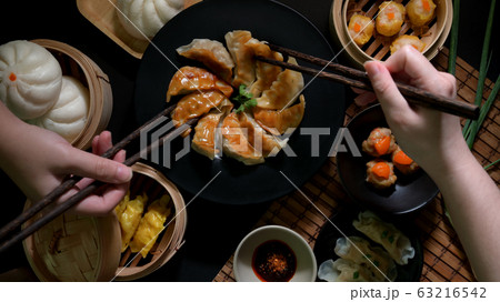 Top view of two female eating Dim sum with Gyoza, Top view of two female eating Dim sum with Gyoza, 63216542