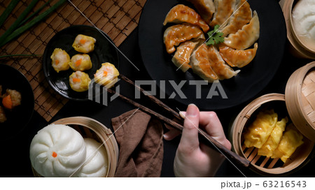 Top view of female eating Dim sum with dumplings, Top view of female eating Dim sum with dumplings, 63216543