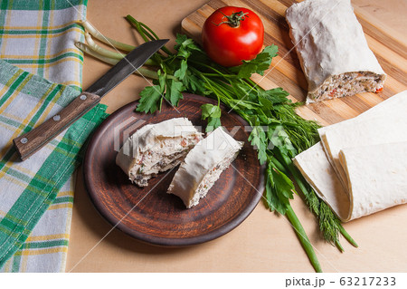 Two pieces of pita bread or lavash roll with 63217233