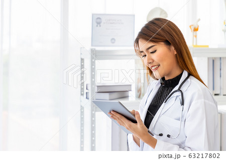 Asian female medical doctor using digital tablet Asian female medical doctor using digital tablet 63217802
