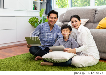 Happy Asian parent sitting together with boy on Happy Asian parent sitting together with boy on 63218174