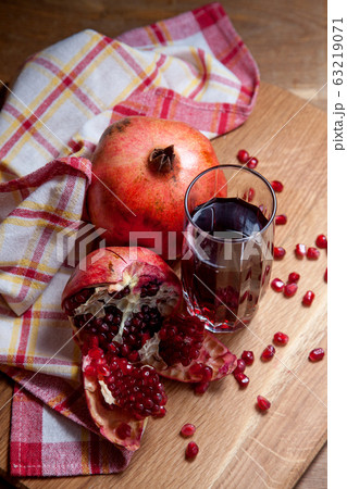 Fresh red pomegranate and glass of fresh rudy Fresh red pomegranate and glass of fresh rudy 63219071